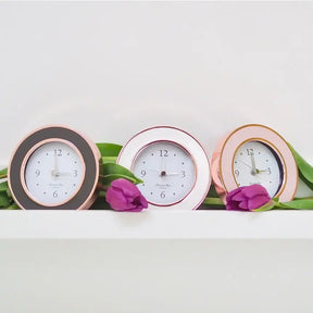Addison Ross Rose Gold Taupe Enamel Clock in a room with other clocks