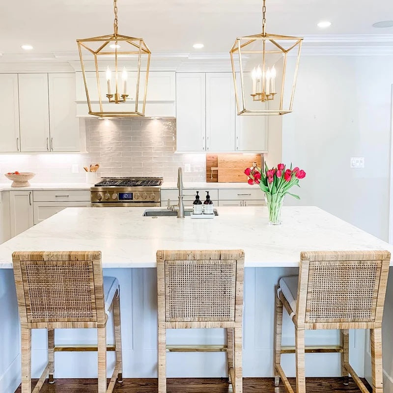 Image of a kitchen island with three Gabby bar stools and two Aerin Chandeliers hanging above the island
