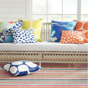 Dash and Albert Summer Stripe Handwoven Indoor Outdoor Rug in a room with a sofa and decorative pillows