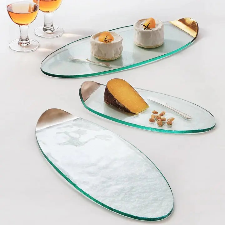 Annieglass Mod Cheese Board in a white room with cheese, nuts and pastries set on top with filled glasses