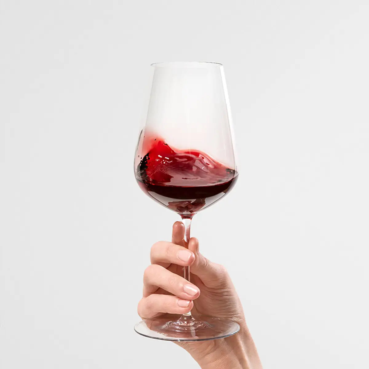 A person holding a Filled Richard Brendon Jancis Robinson Wine Glass