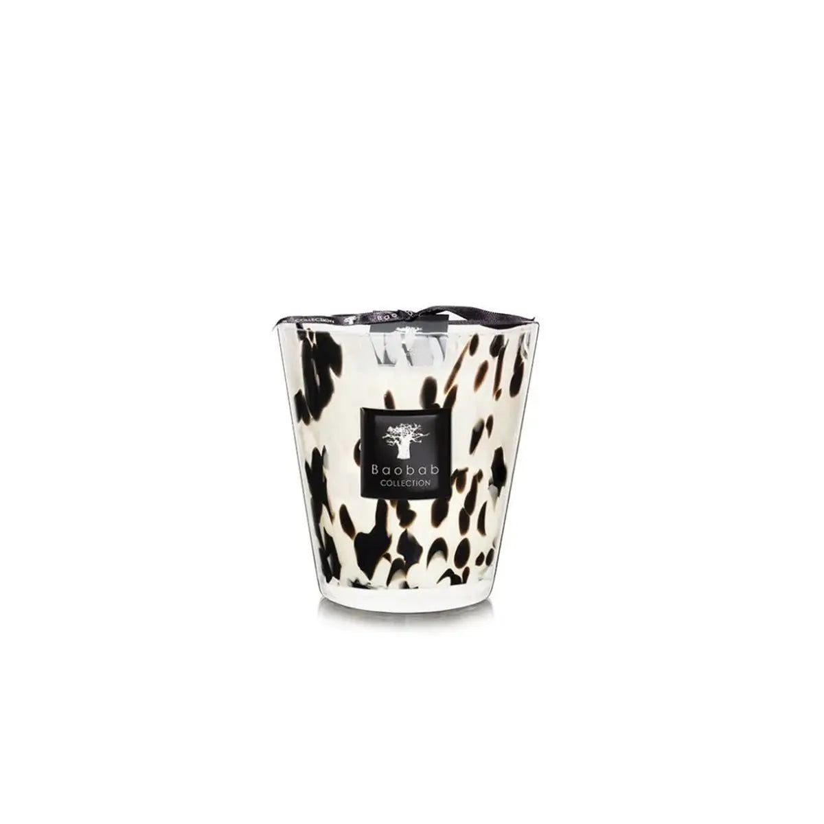 Baobab Collection Max 16 Pearls Black Candle set on top of a table and a book