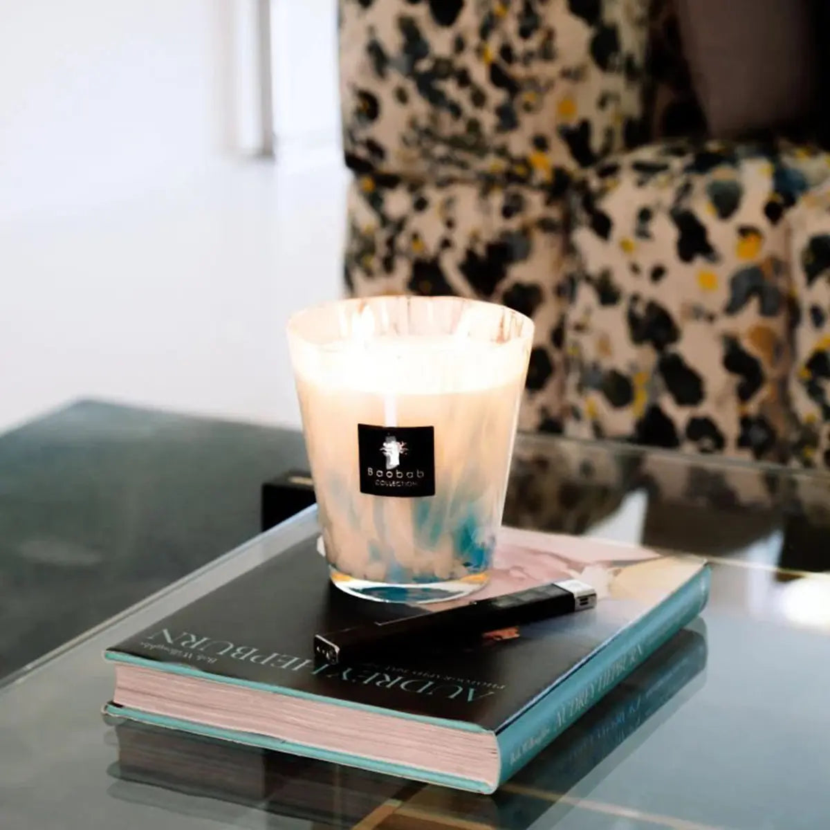 Baobab Collection Max 16 Pearls Sapphire Candle set on top of an end table and book in a room