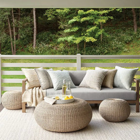 Dash and Albert Veranda Ivory Handwoven Rug outdoors with patio furniture