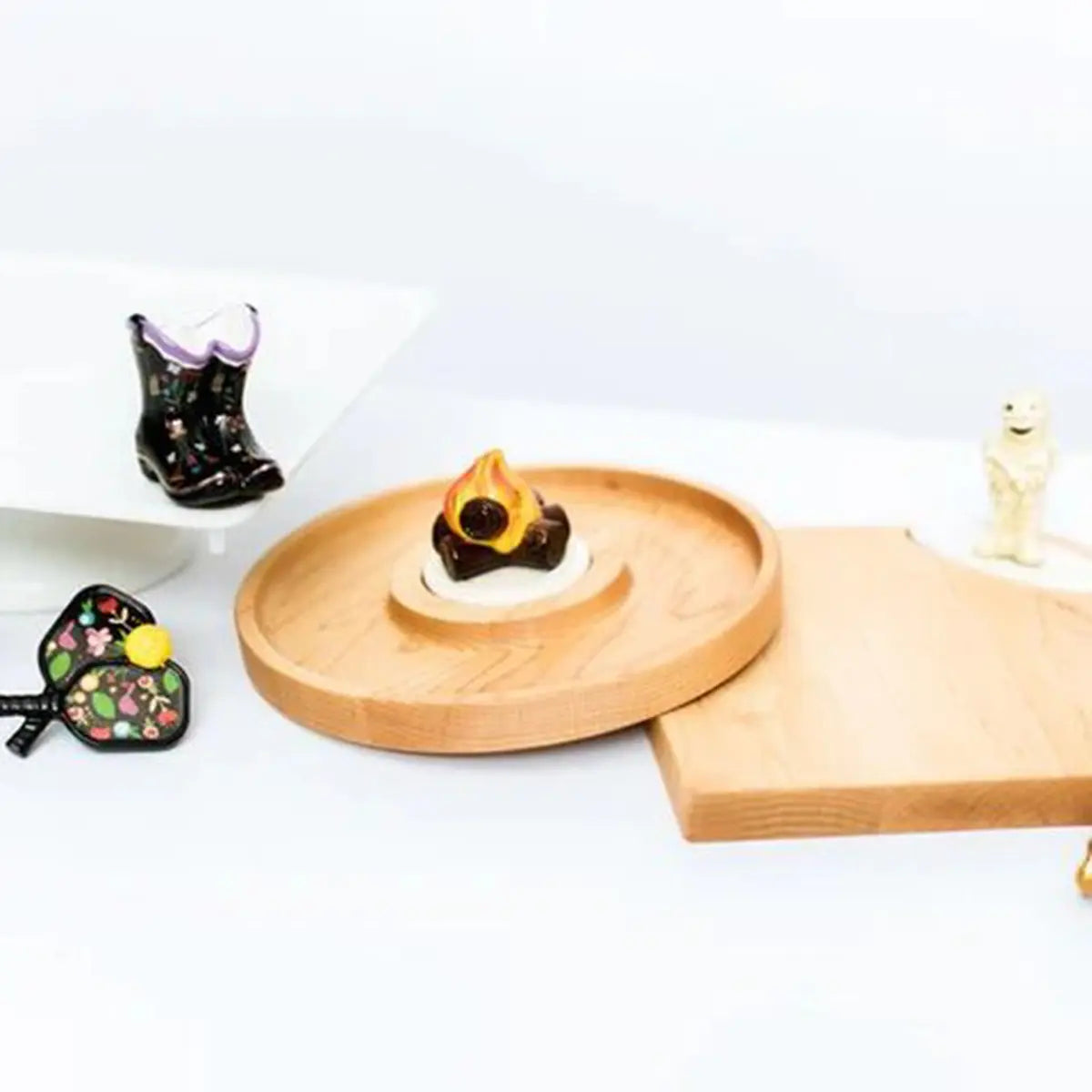 Nora Fleming Day Dinking Pickle Ball Mini set next to wooden trays
