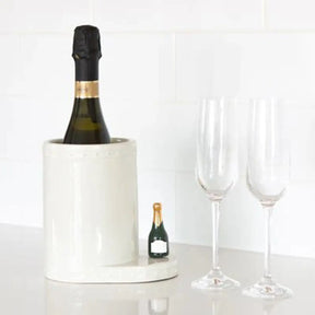 Nora Fleming Champagne Celebration Champagne Bottle Mini on a champagne holder in a room.