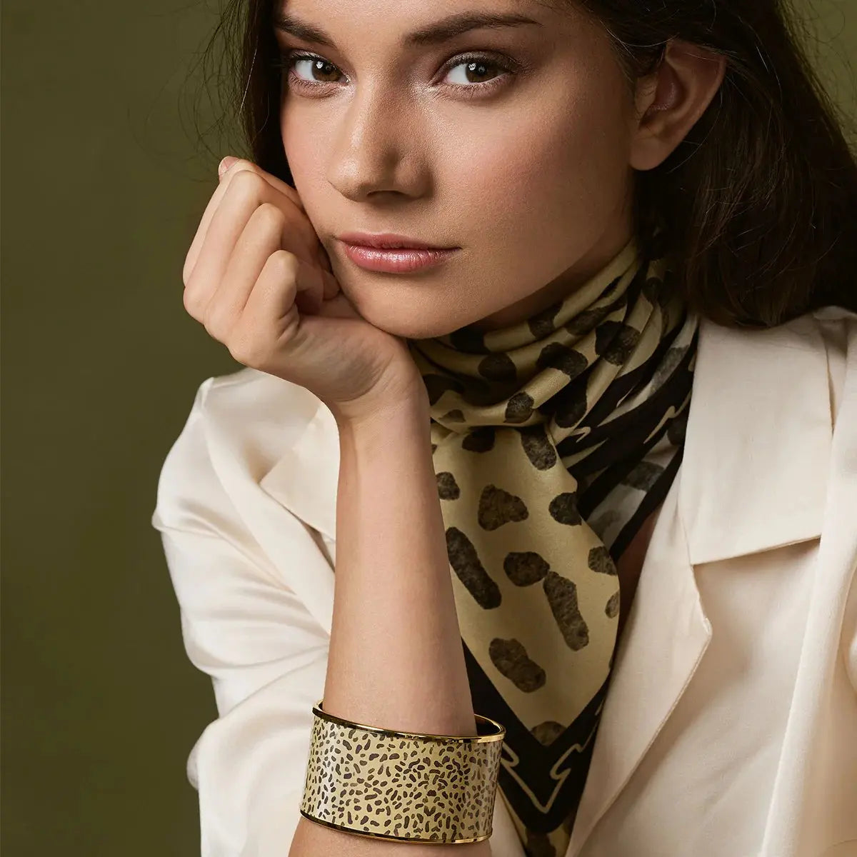 A woman wearing Halcyon Days Leopard Gold Enamel Cuff Bangle