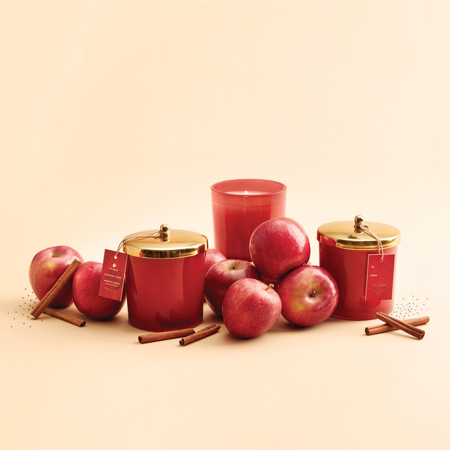 An image of Thymes Simmered Cider Harvest Red Large Candle 13 oz