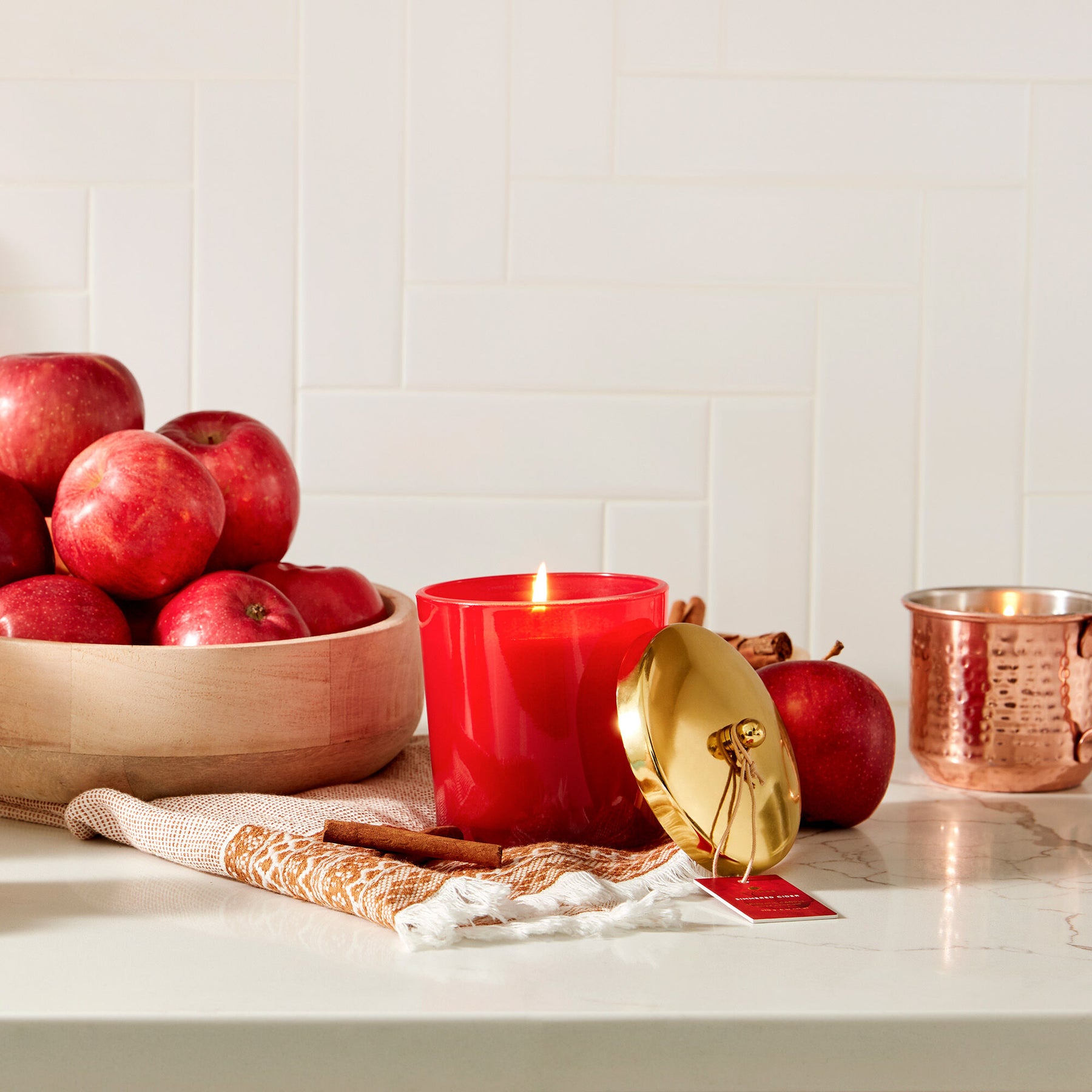 An image of Thymes Simmered Cider Harvest Red Large Candle 13 oz