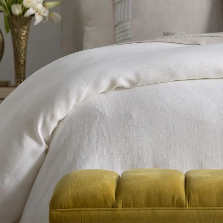 Lili Alessandra Rain Duvet Cover in White Cotton and Linen draped on a bed in a room