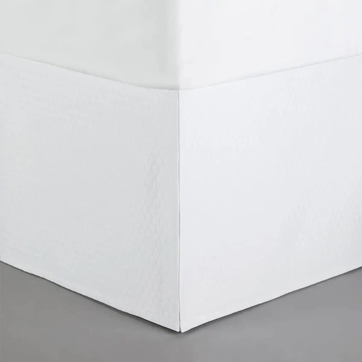 Sferra Favo Bed Skirt in White on a bed