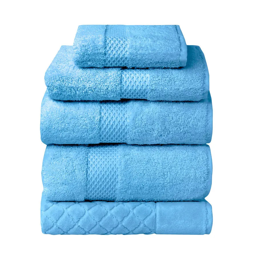 Yves Delorme Etoile Bath Towels and Rug Collection in Cobalt color stacked together