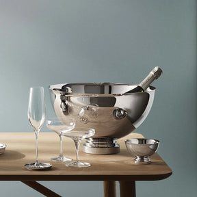 Georg Jensen Manhattan Stainless Steel Champagne Bowl set on a table with glassware