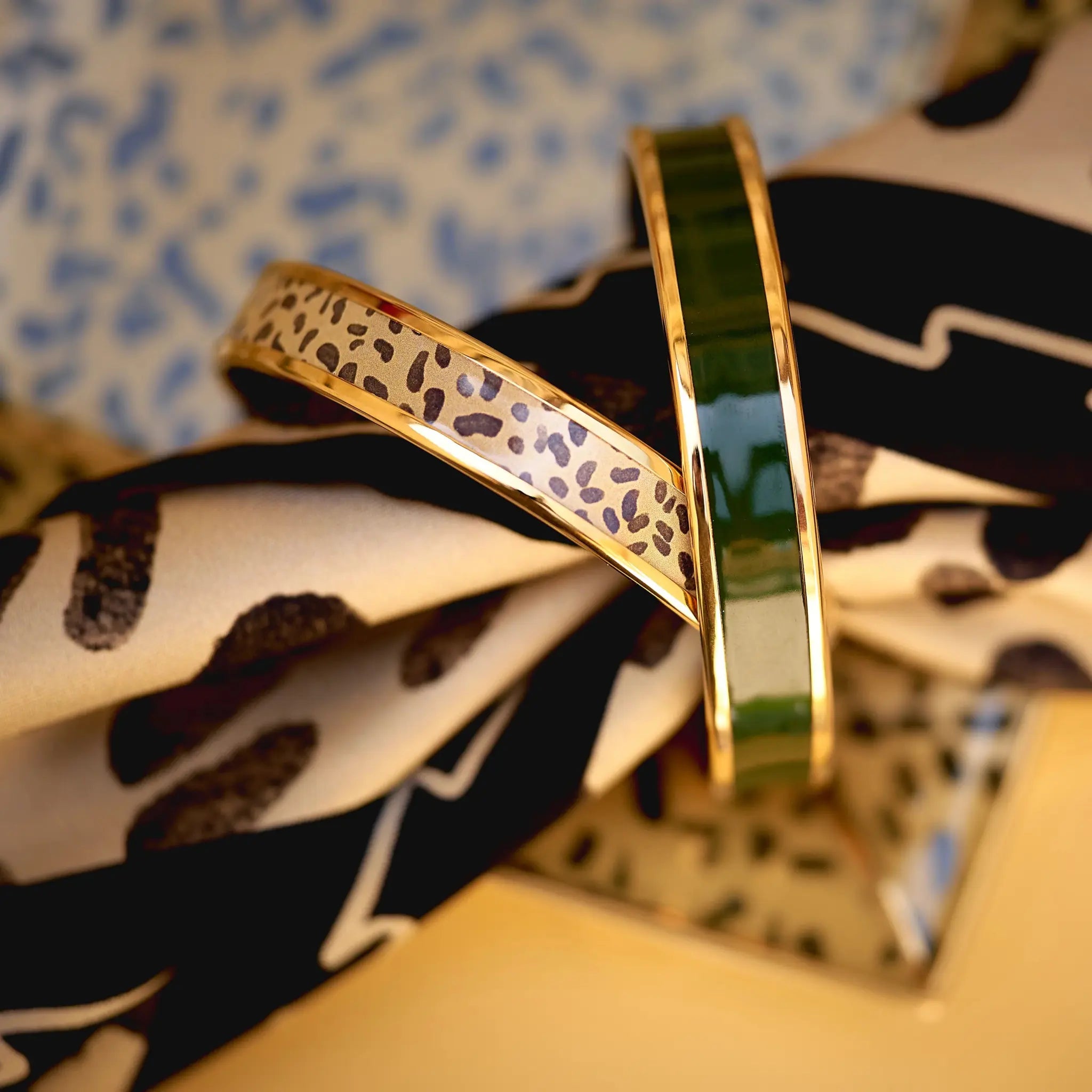Halcyon Days Leopard Gold Enamel Bangle on a scarf in a room