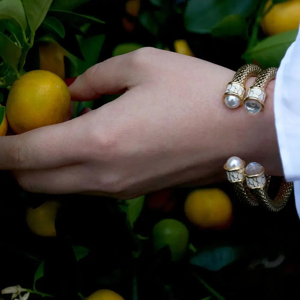 Woman wearing  Halcyon Days Salamander Torque Bangle in Pearl and Gold