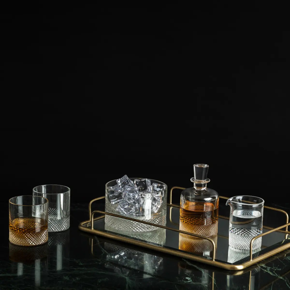 Richard Brendon Diamond Ice Bucket in a black room with a tray and other glassware