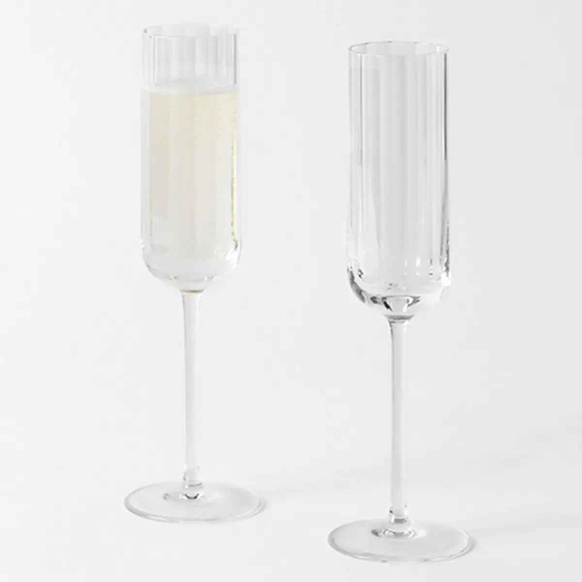 Richard Brendon Pair of Fluted Champagne Flutes with one filled and one empty