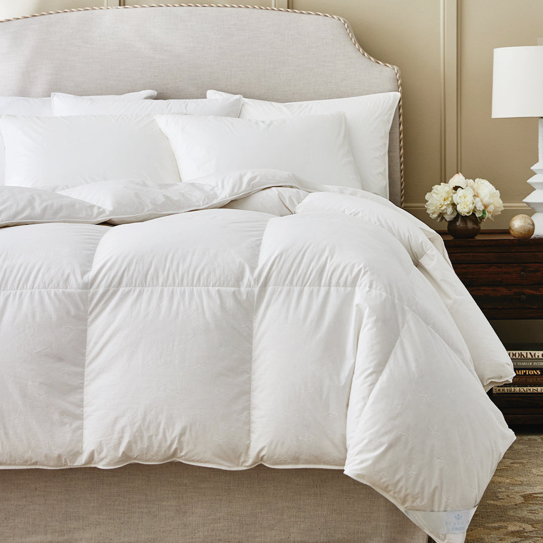 Image of Comforters & Duvet on luxury bed with flowers and lamp on accent table