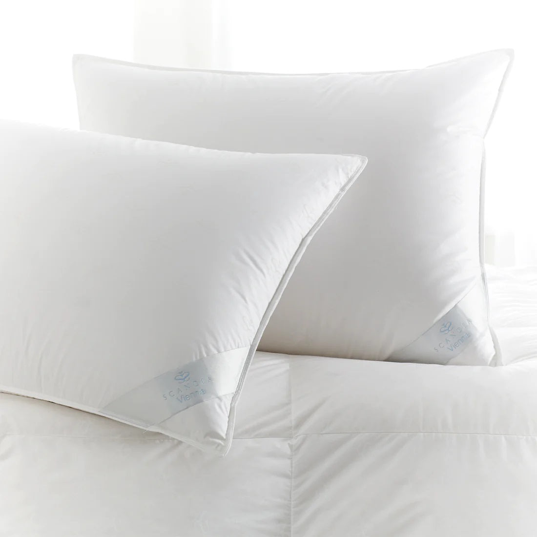 Image of white luxurious Pillows on top of bed