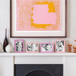 Addison Ross Enamel with Fuchsia Silver Frame set on a mantel in a room