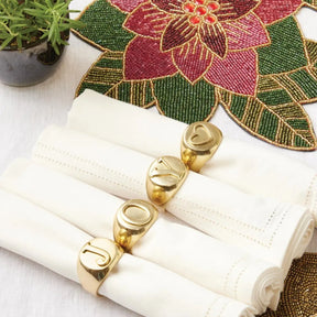 Blue Pheasant Clark J O Y Gold Napkin Rings on a napkin in a room