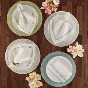 Bodrum Pearls Round Placemat and Napkin in in four colors on a table with a dinner napkin
