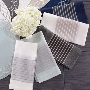 Bodrum Tuxedo Napkin Collection in various colors set on a table with flowers and placemats