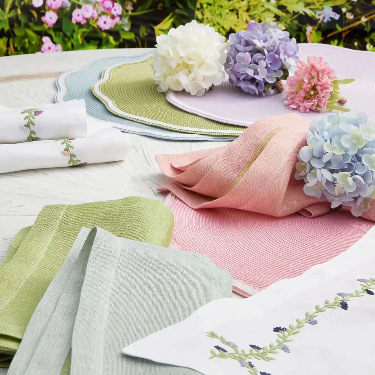 Deborah Rhodes Hydrangea Garden Napkin and blossom napkin ring on a set table 