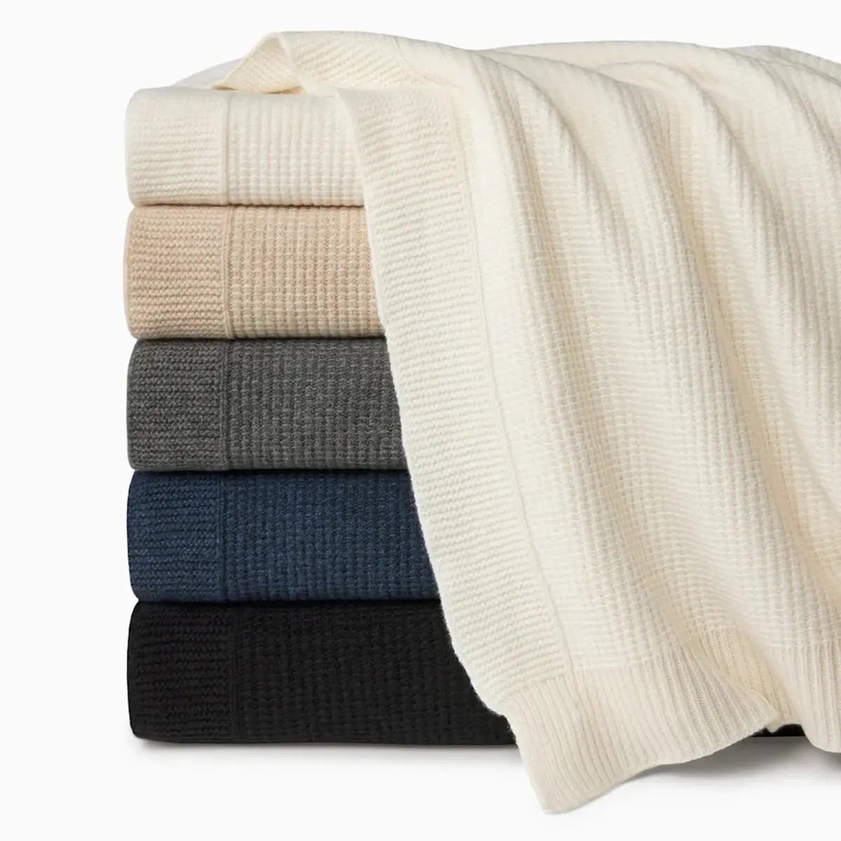 Sferra Pettra Lambswool Throws stacked in a room