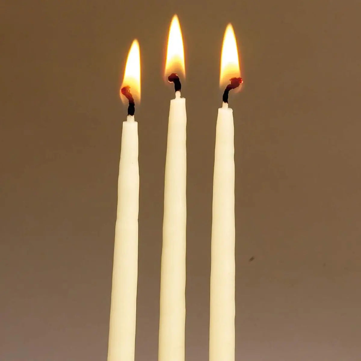 three Rite Lite Hand Dipped Natural Wax Ivory Hanukah Candles lit