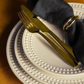 L'Objet Perlée White Dinner Plate in a room with food and a plant