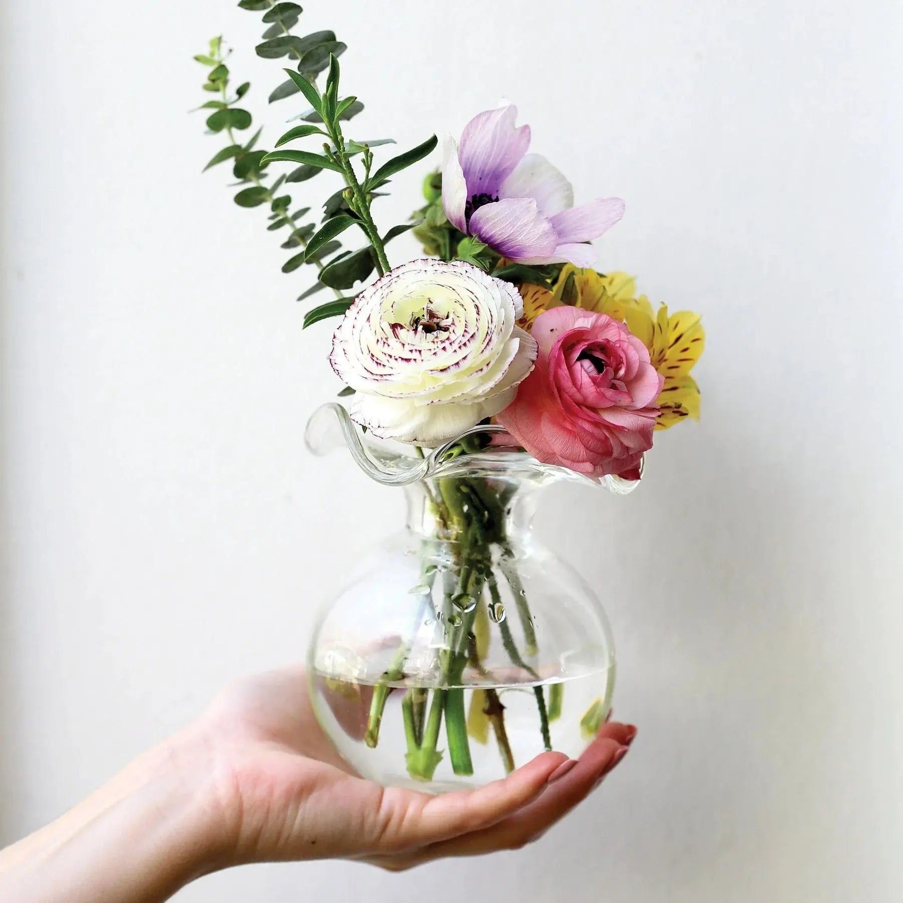 Vietri Hibiscus Clear Glass Bud Vase in a room