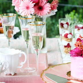 Three filled Vietri Optical Champagne Glasses on a table setting with flowers and parfaits 