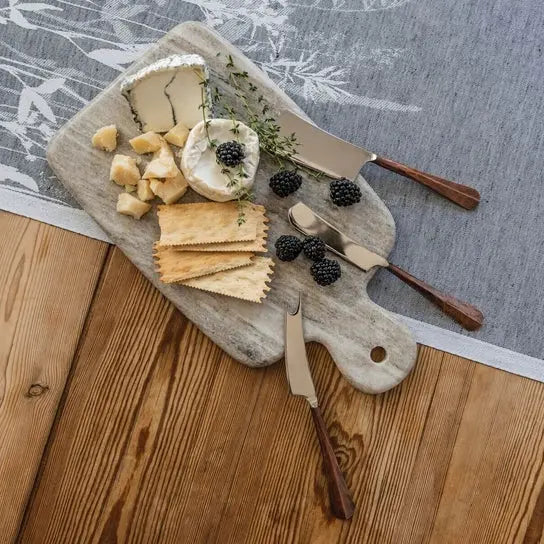 Simon Pearce Beige Medium Marble Board with crackers, cheese and blackberries on top with serving knives