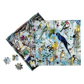Open box of Hachette Christian Lacroix Birds Sinfonia Puzzle with several puzzle pieces scattered 