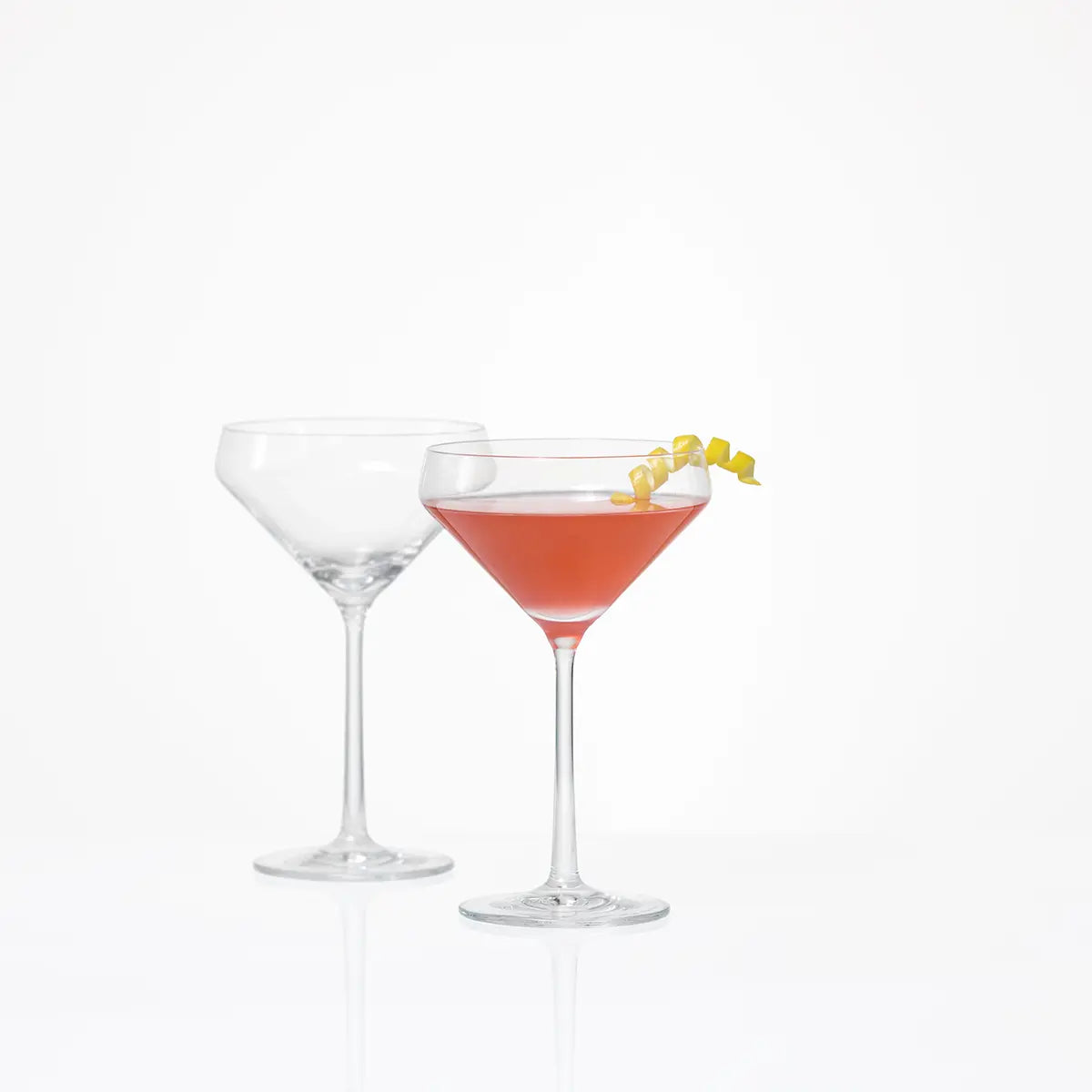 A pair of Fortessa Tritan Pure Martini Glass with one empty and one filled