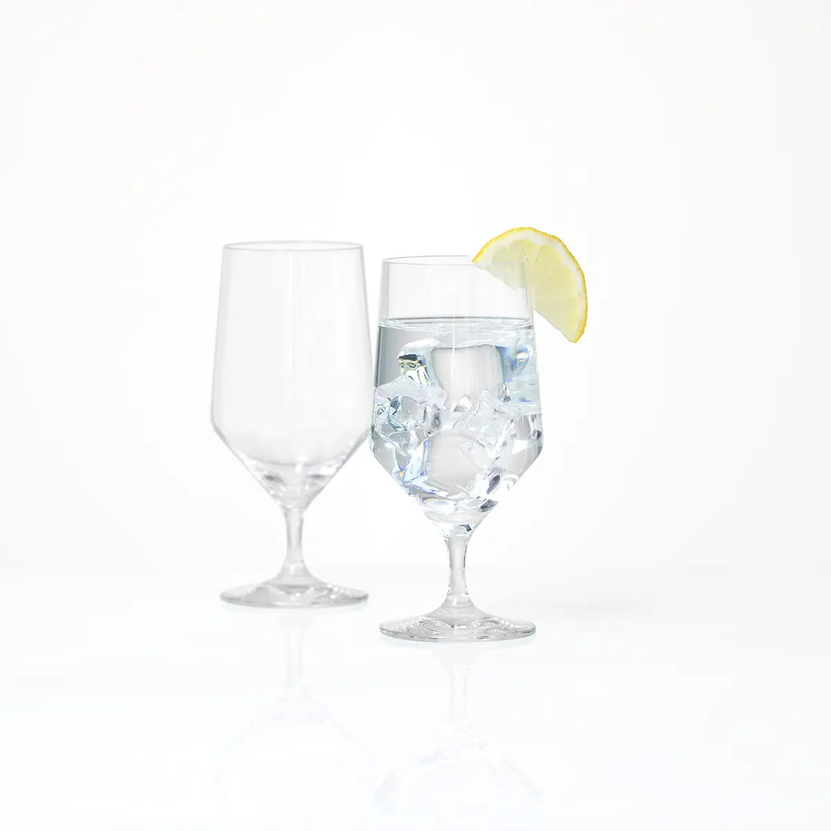 Pair of Fortessa Tritan Pure Beverage Water Glass with one filled with a lemon and one unfilled
