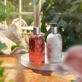 Molton Brown Heavenly Gingerlily Body Lotion on a tray within a room of plants