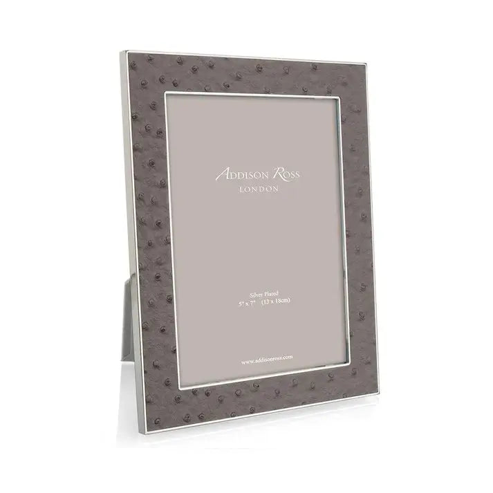 Addison Ross Faux Ostrich Frame in Twilight Color set on a table next to a lamp in a room