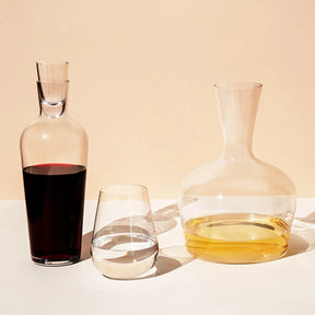 Filled Richard Brendon Jancis Robinson Young Wine Decanter, old wine decanter, water glass in a room.