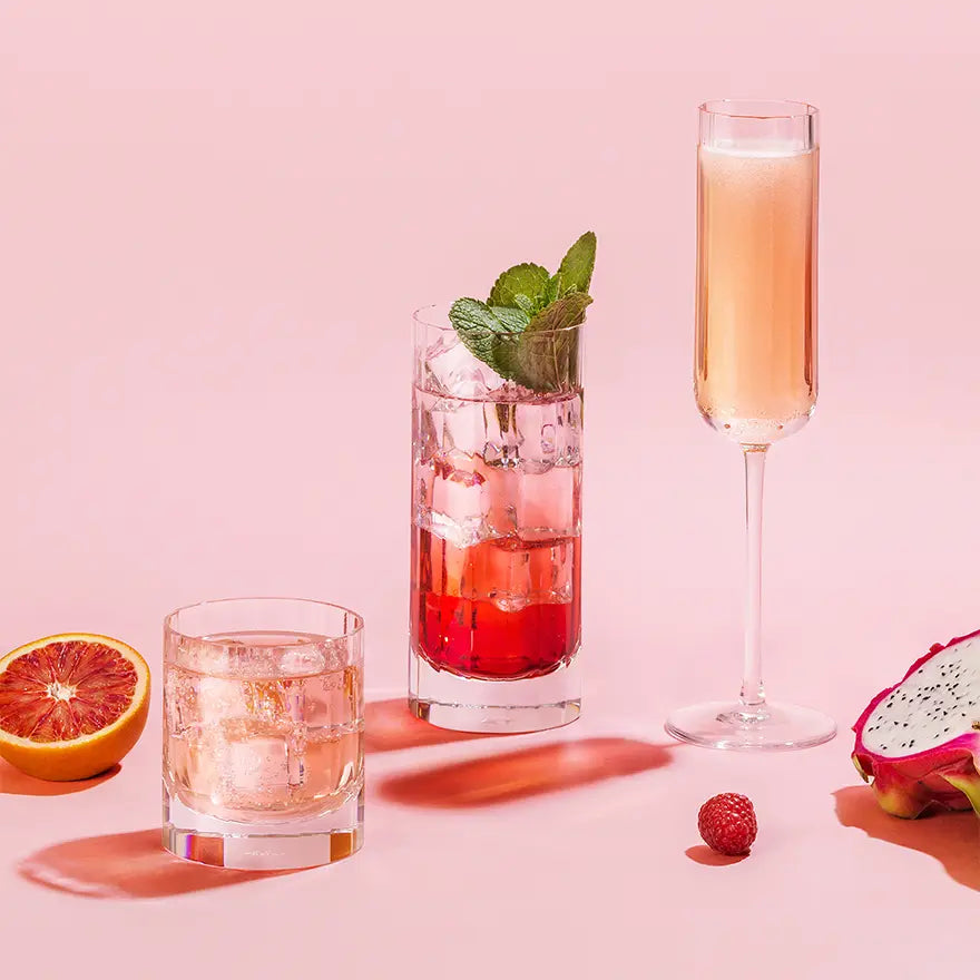 Richard Brendon Fluted Highball, old fashioned glass and fluted champagne glass in a pink room with fruit