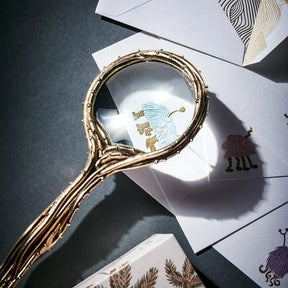 L'Objet Haas Optipus Magnifying Glass set on some white envelops with designs in a room