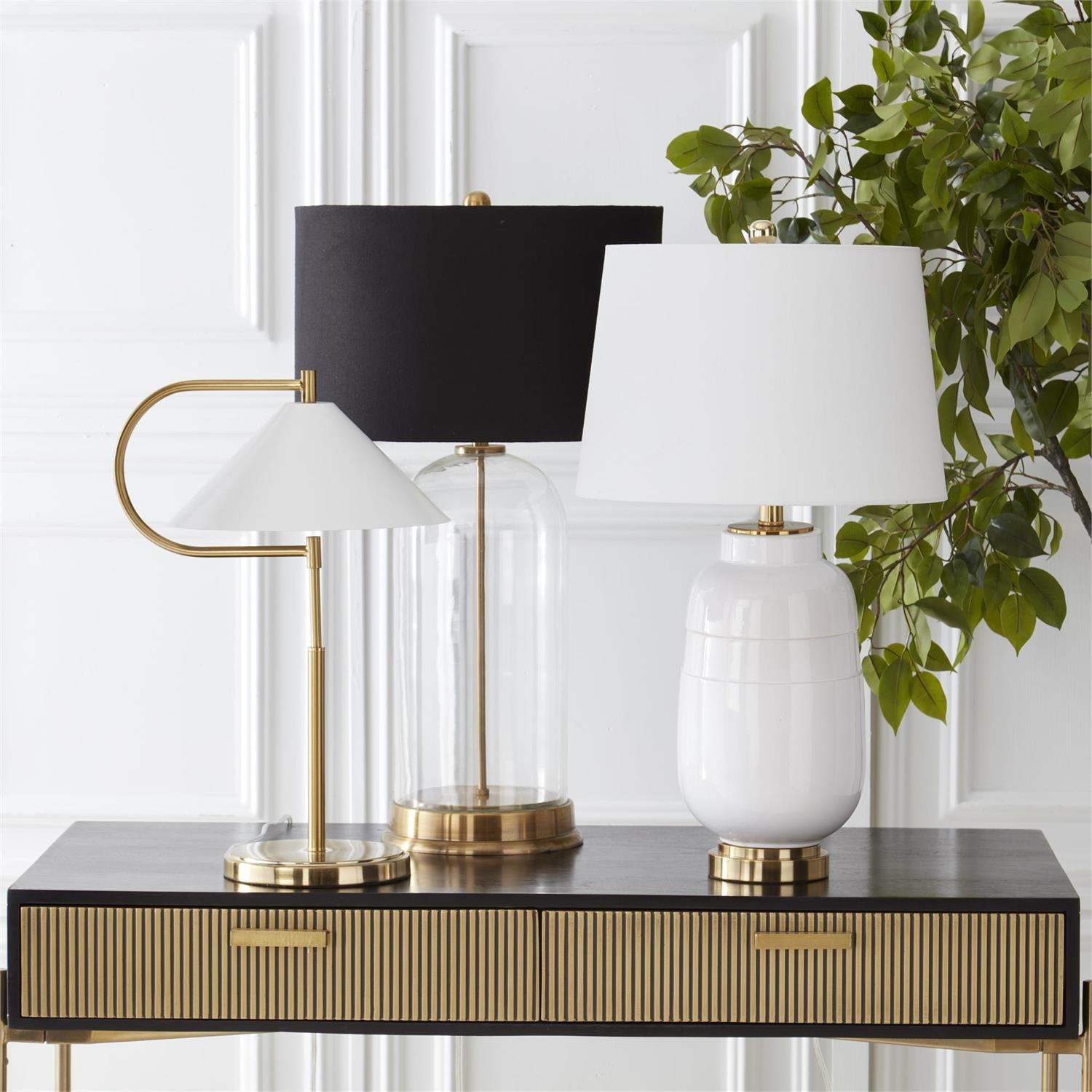 An image of K&K Interiors 29.5" Clear Glass Lamp w Gold Metal Spine and Black Shade