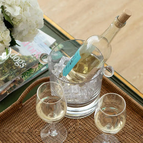  Caspari Crystal Clear Acrylic Ice Bucket and Lid  outside on a table with a champagne bottle inside with other glassware