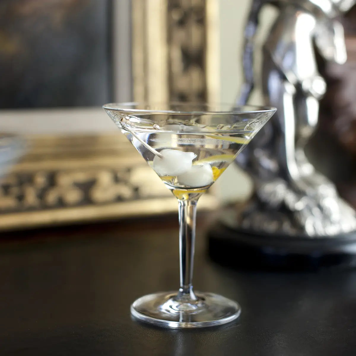 Filled Fortessa Classic Bar Martini set in a room next to a picture frame and home decorative item