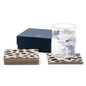 Blue Pheasant Harper Coasters Set of 4 stacked with gift box and a glass of water