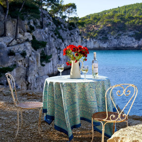 Caravan La Mer Tablecloth on a round table outside by the lake