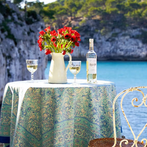 Caravan La Mer Tablecloth on a round table outside by the lake