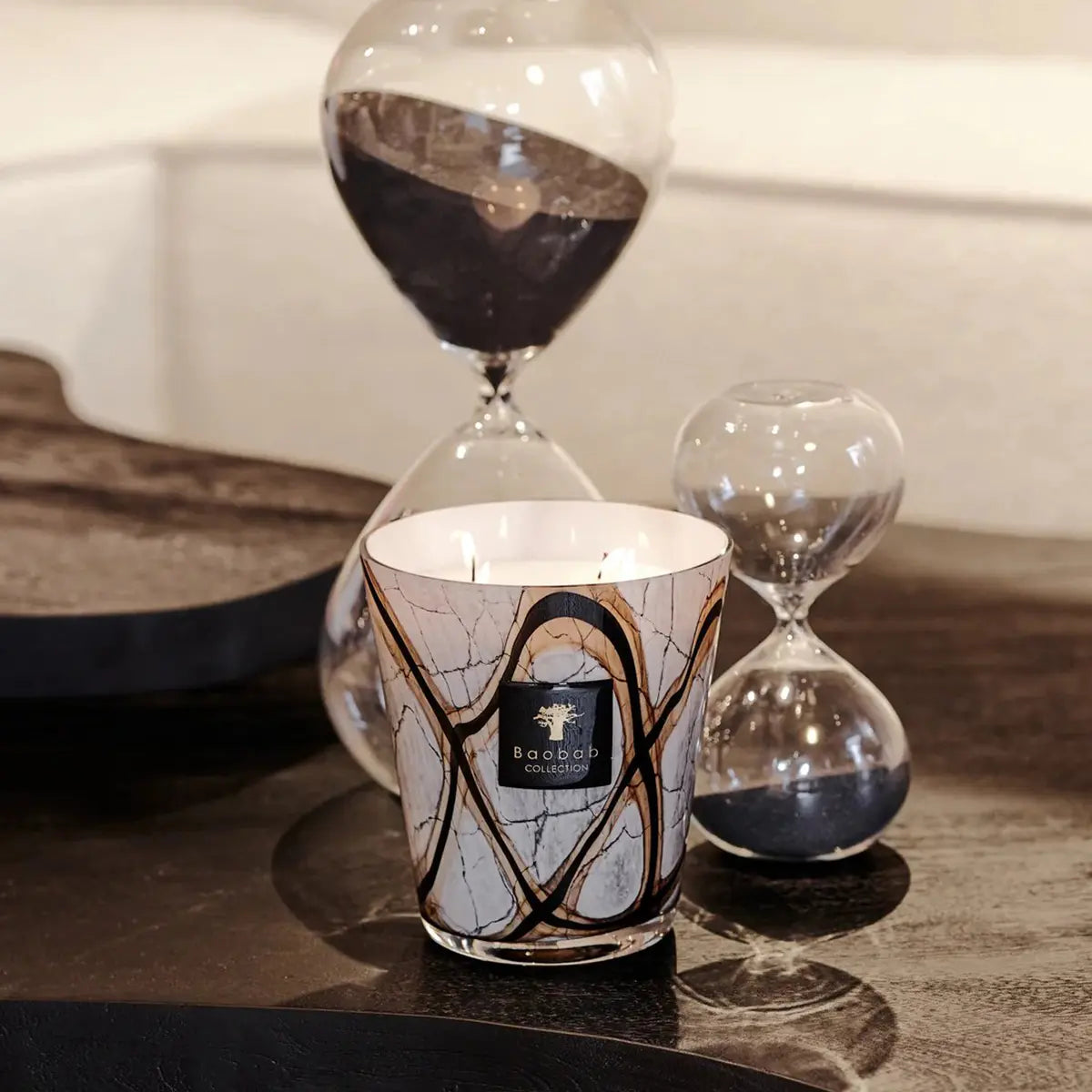 Baobab Collection Max 16 Stones Marble Candle set on a coffee table in a room with hourglasses