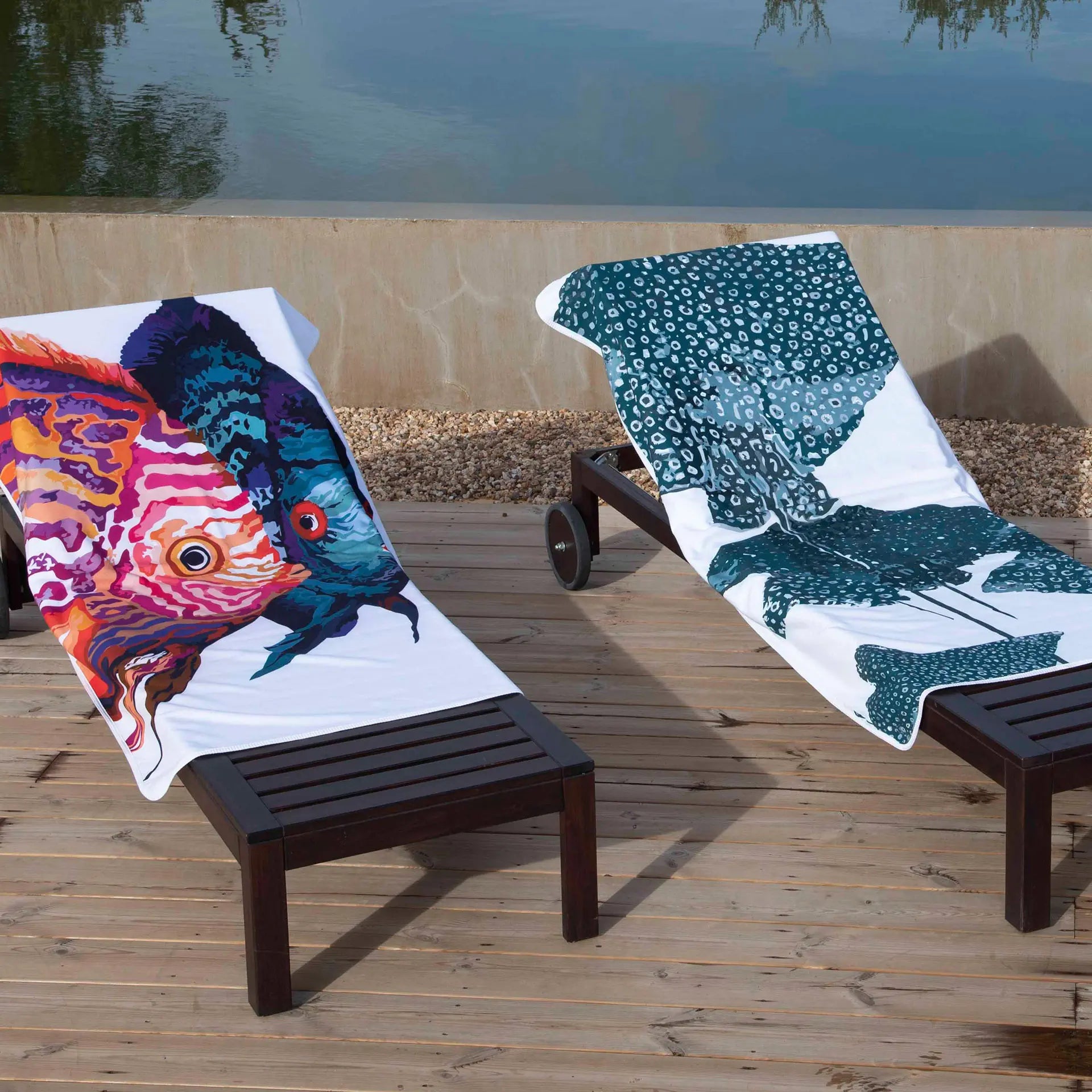 Graccioza Sting Ray Beach Towel laid on a beach lounge chair on a beach